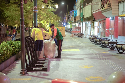 Men working together to pick up trash and beautify a city street in Cleveland.