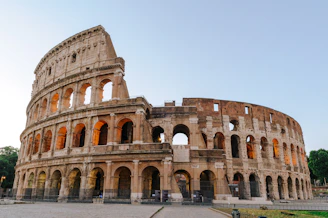 The Colosseum in Rome under a clear sky during the golden hour