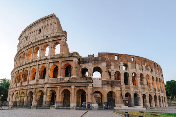 The Colosseum in Rome under a clear sky during the golden hour