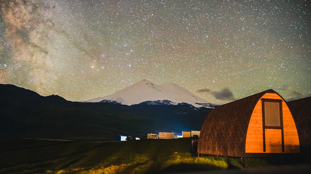 a tent in a field with a mountain in the background