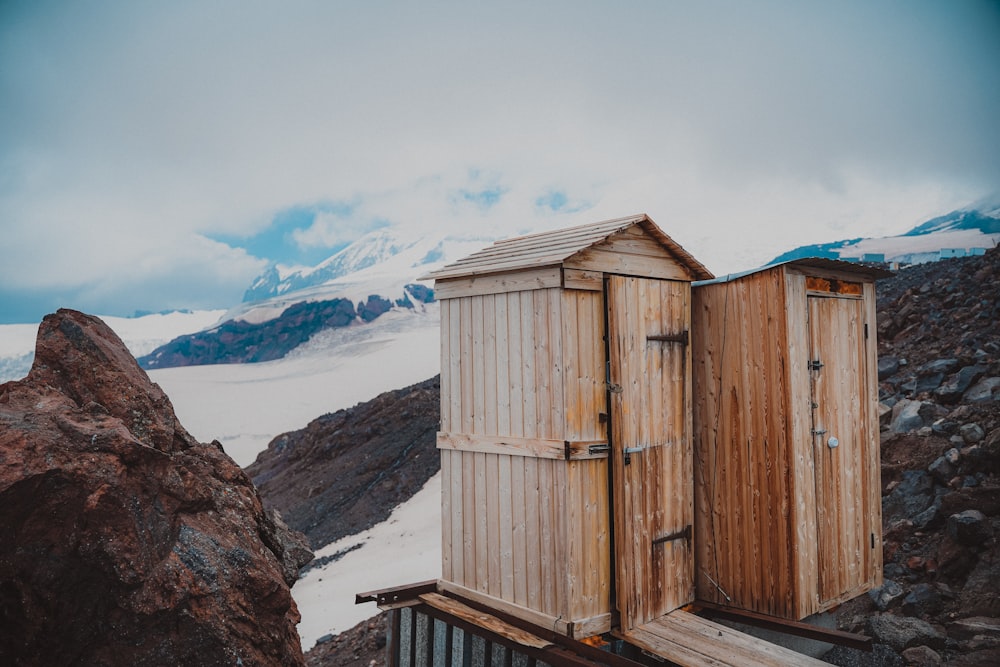 a group of wooden buildings on a rocky mountain