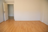An empty bedroom with plain walls and bare floors before virtual staging.