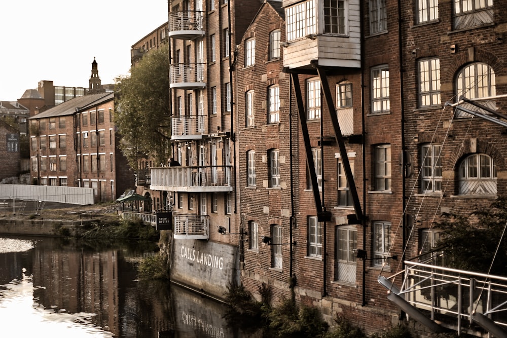 a brick building with a river in front of it