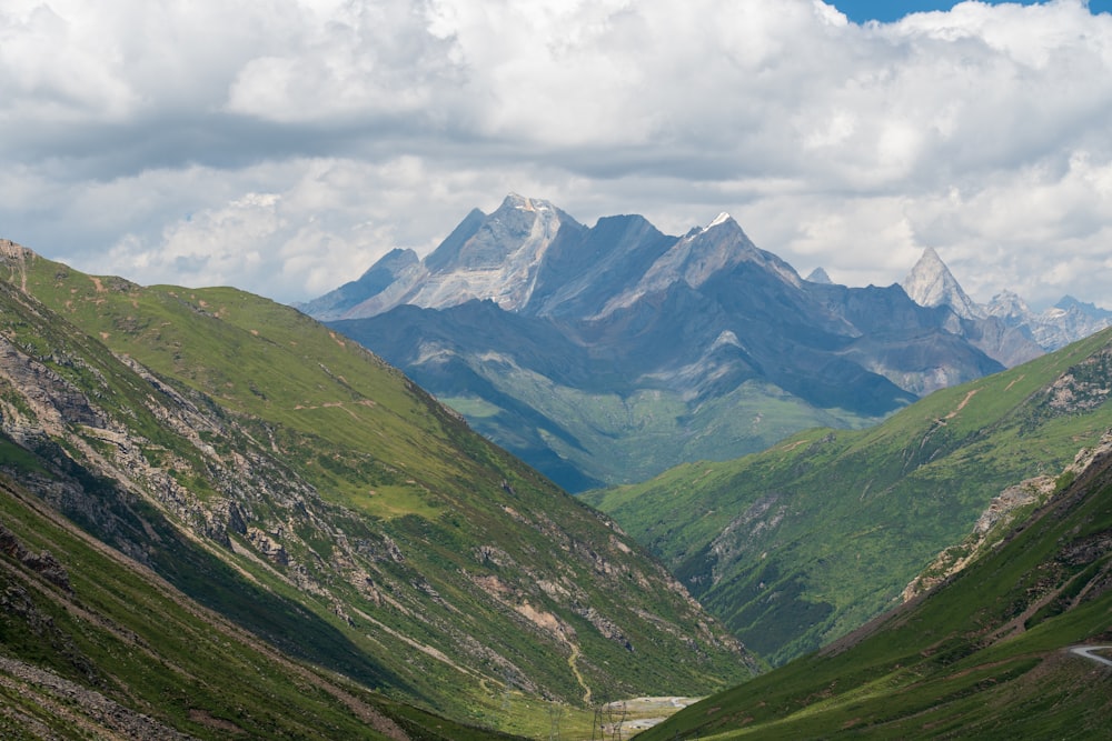 a valley with mountains in the background