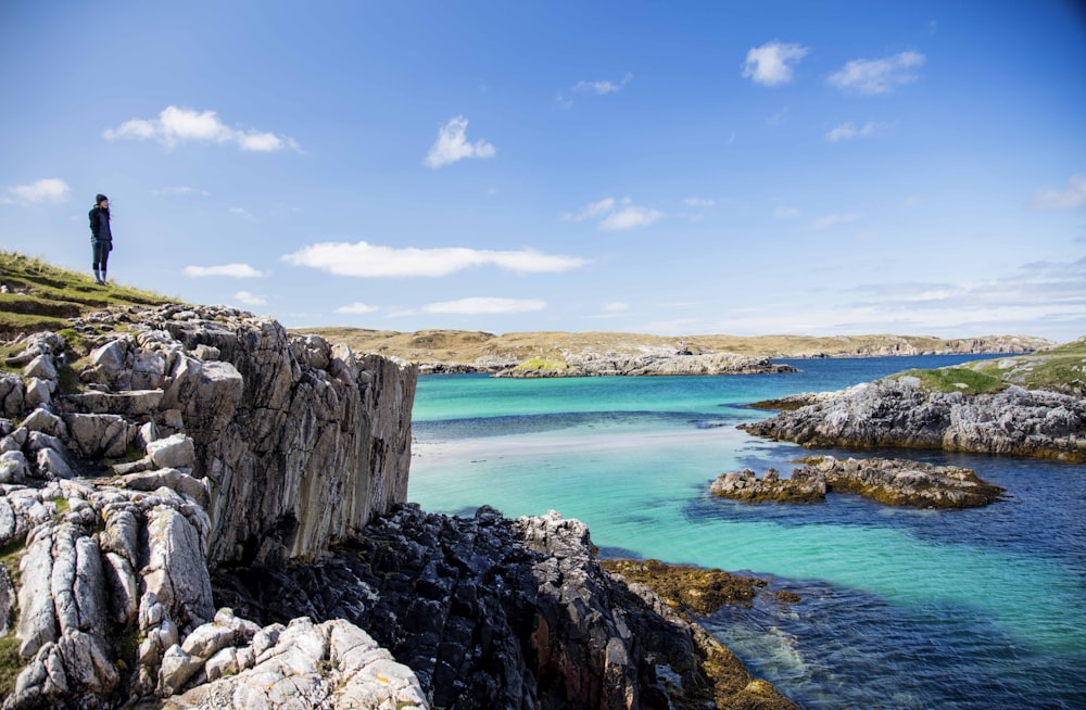 a person standing on a rocky cliff