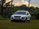 A luxurious SUV parked in front of a tropical resort.
