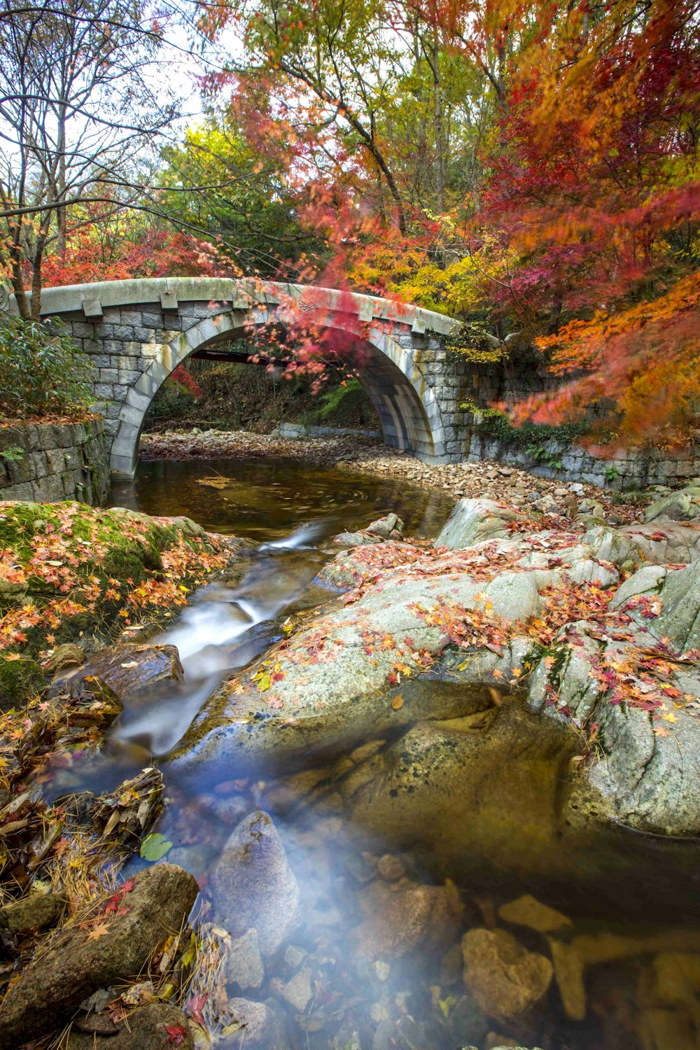 a stone bridge over a river