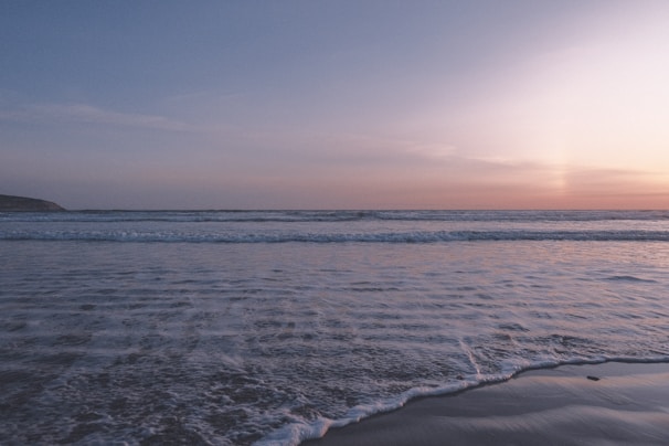 Sunset view from our recent trip to the coast, waves gently crashing on the shore.