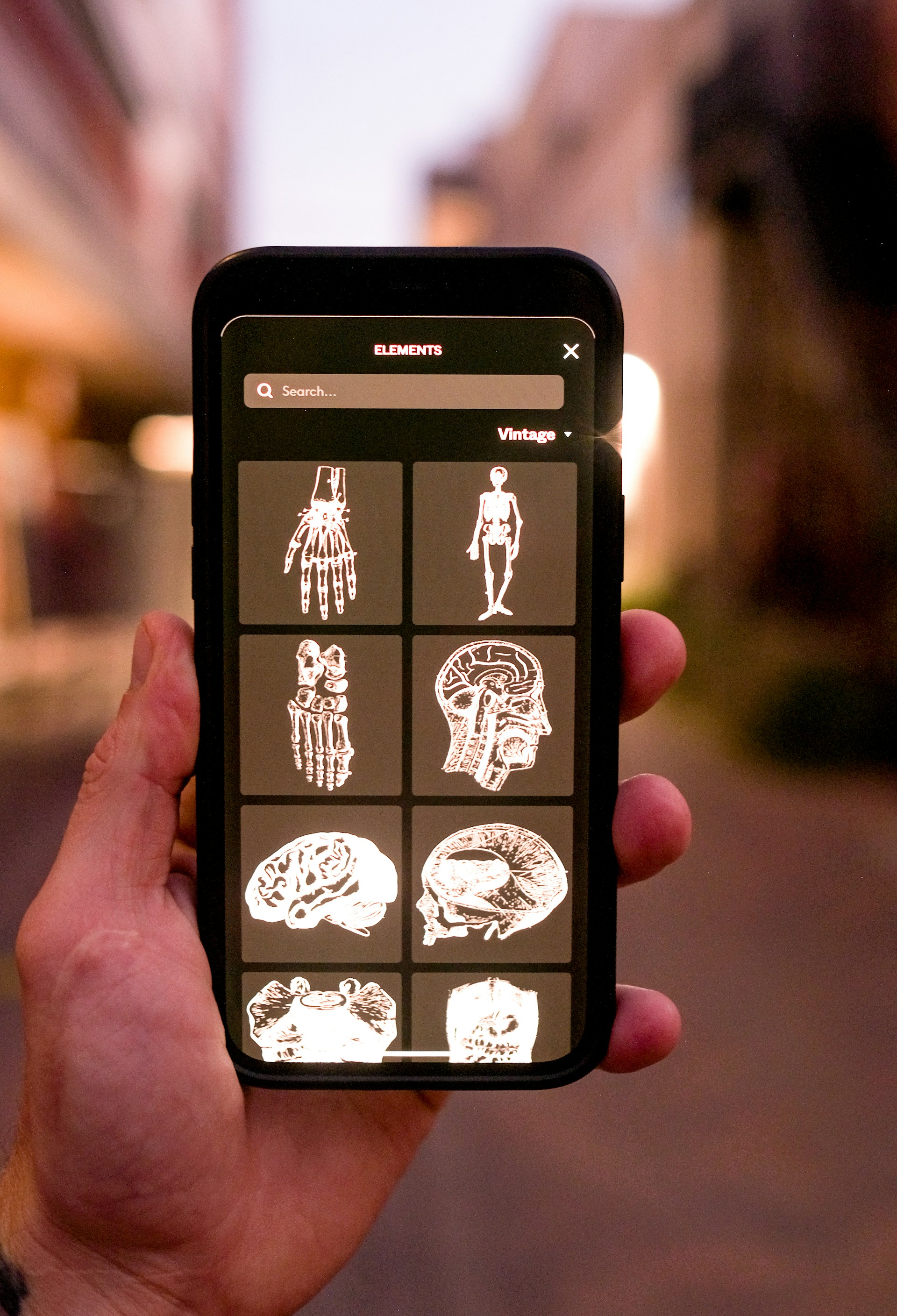 a hand holding a cell phone