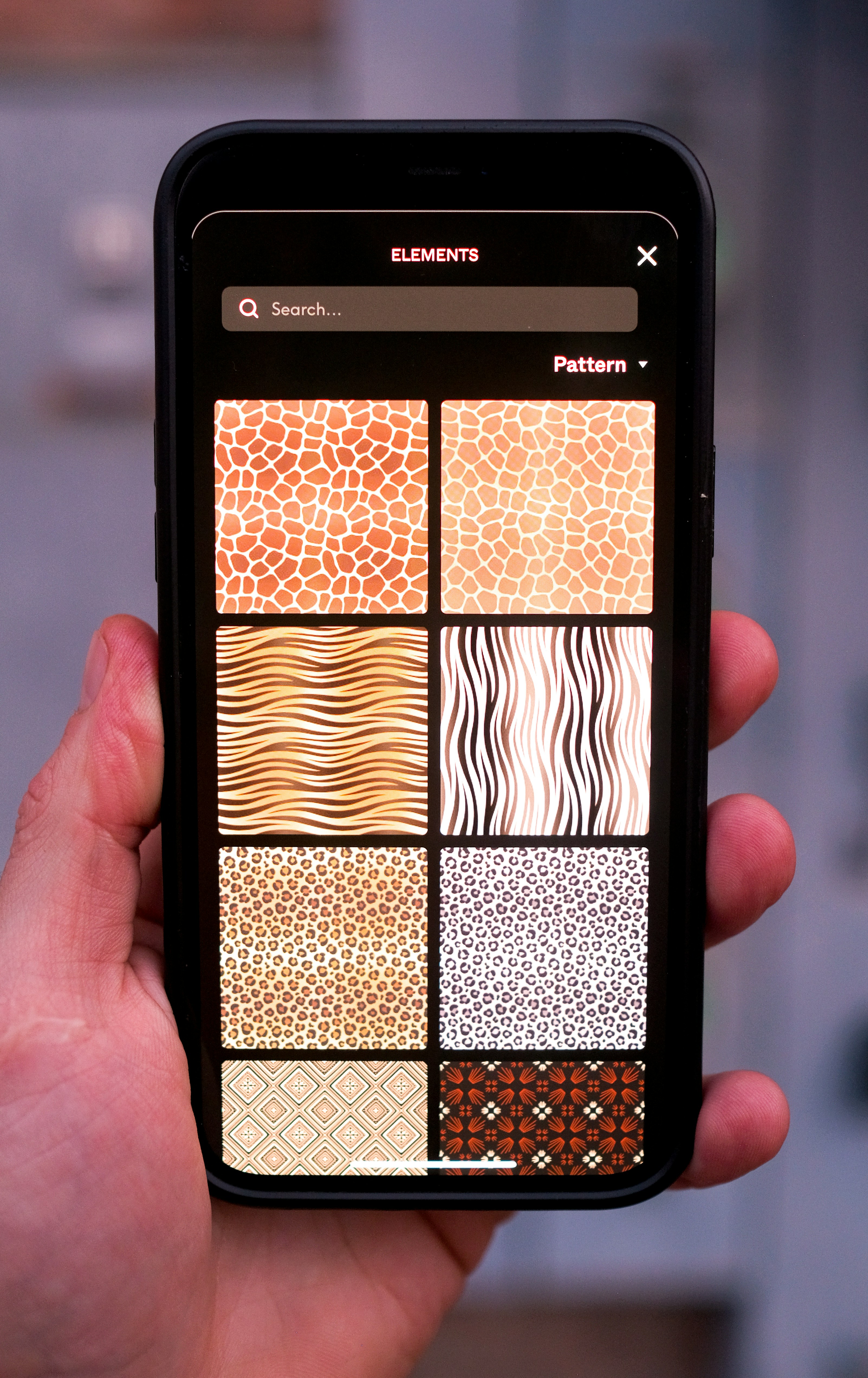 a hand holding a cell phone