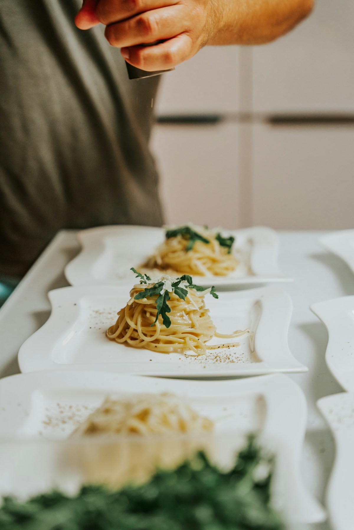 Chef finishing cacio e pepe pasta tableside at Felice a Testaccio — Rome's most legendary version of the dish
