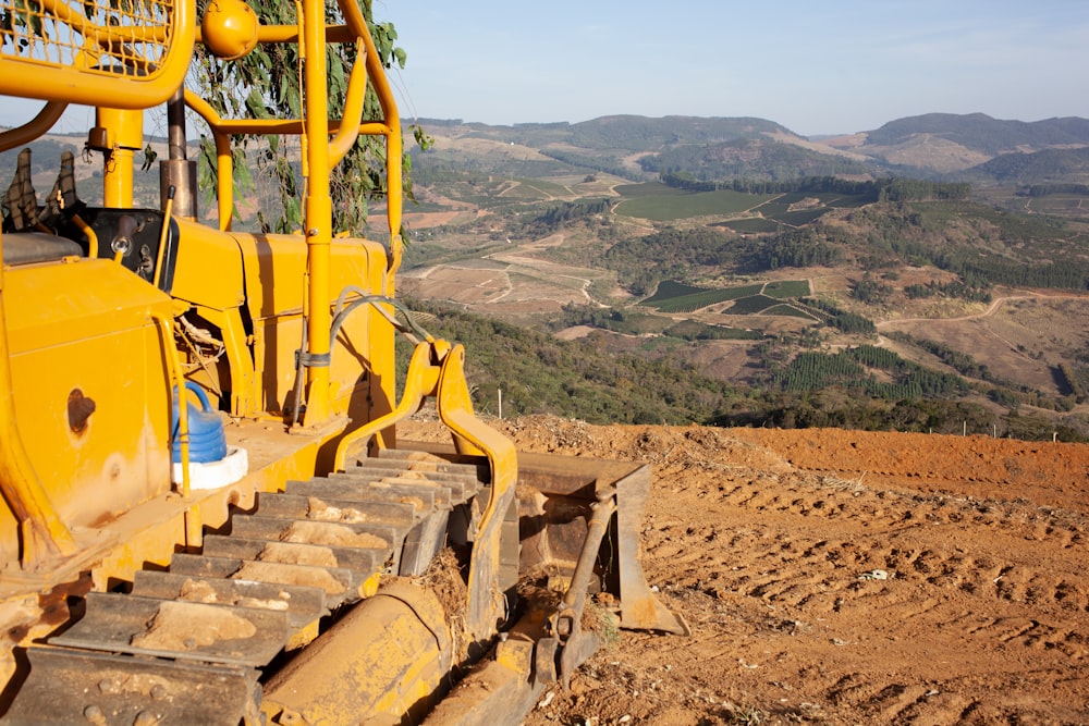 a yellow machine on a hill