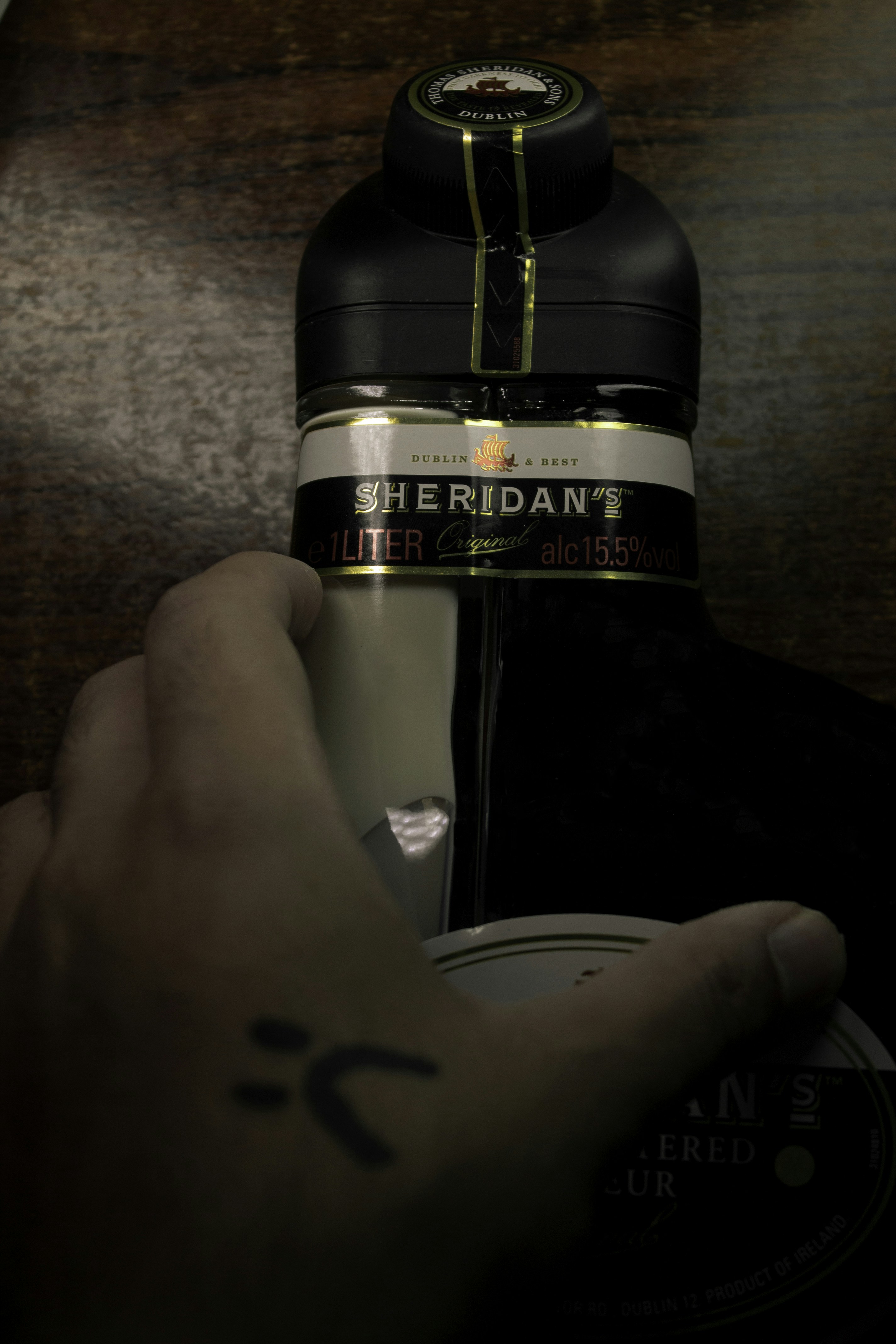 a hand holding a bottle