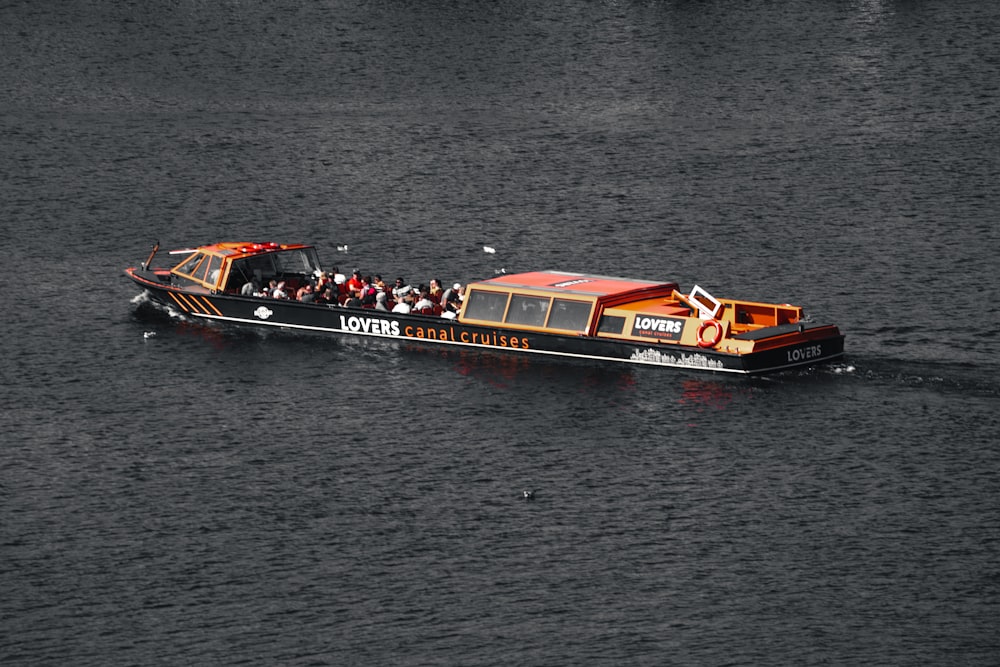 a boat full of people sailing on the water