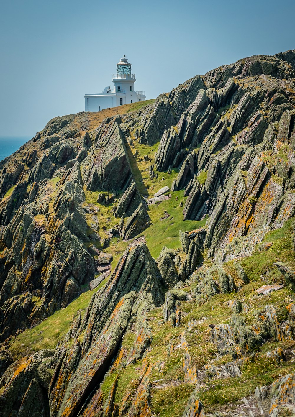 a lighthouse on a rocky hill