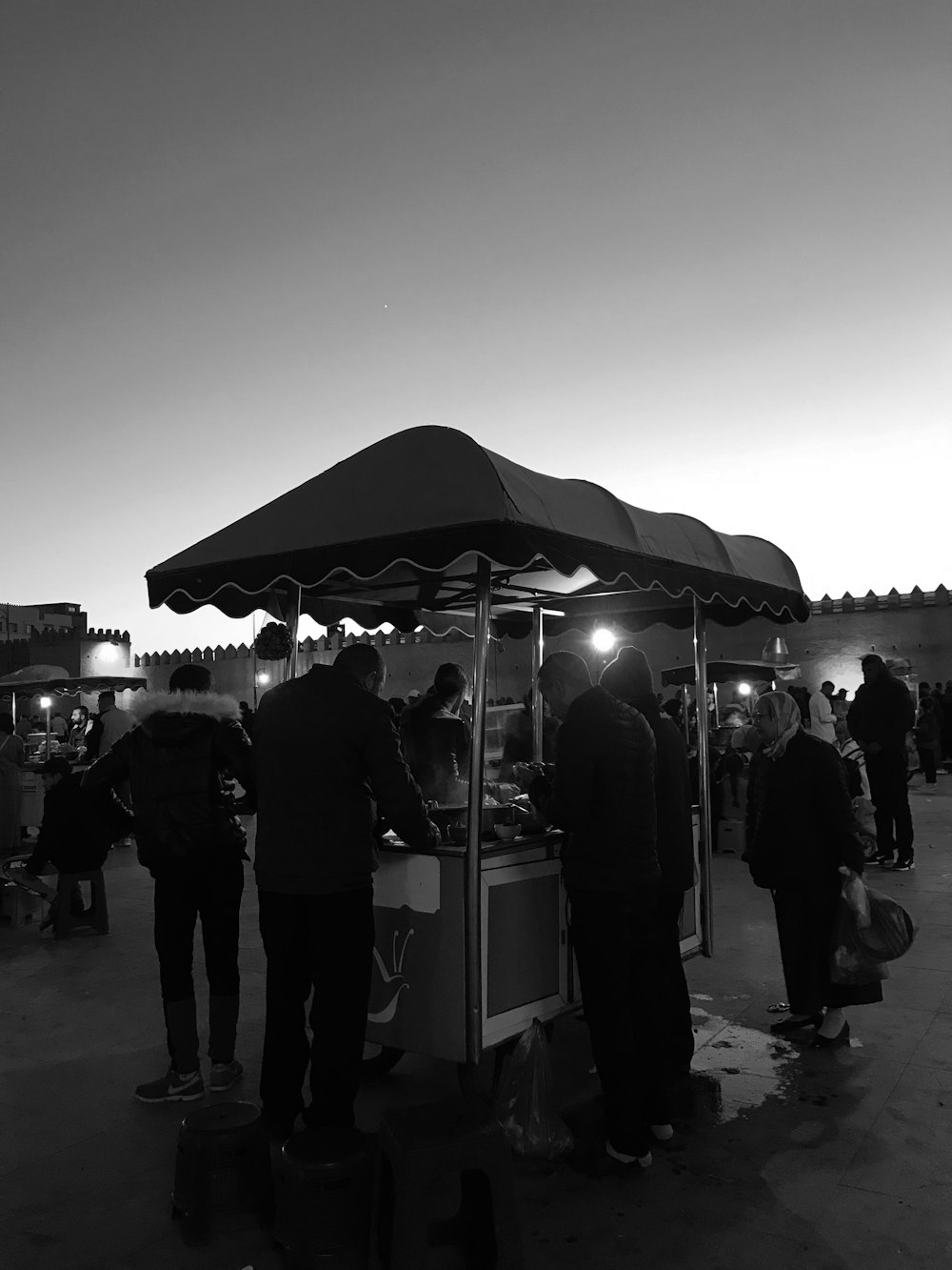 a group of people standing outside a tent