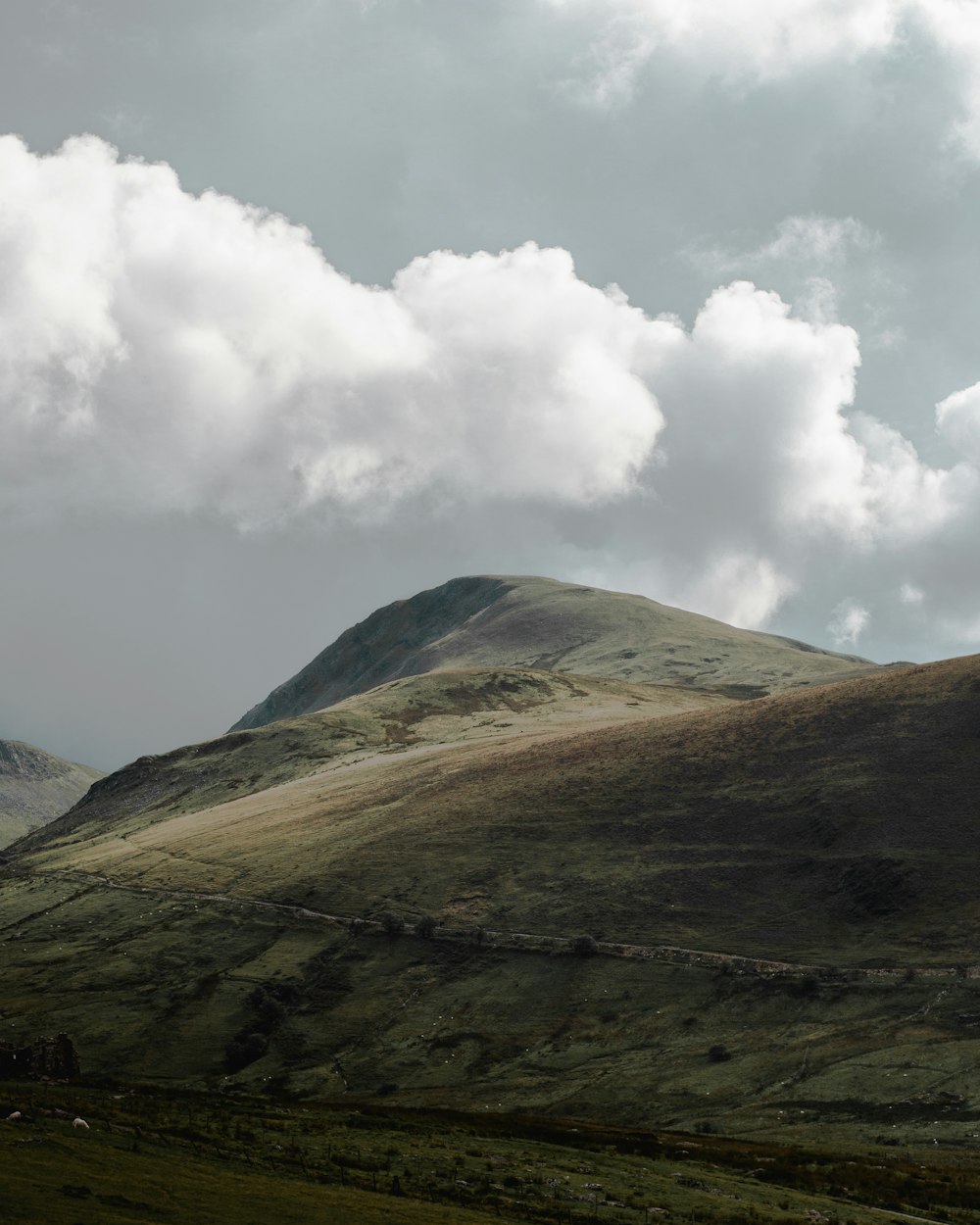 a mountain with clouds above it