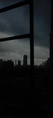 Screenshot of a moody, pixel-art cityscape from an indie game in dark mode.