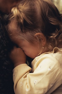 a woman kissing a baby