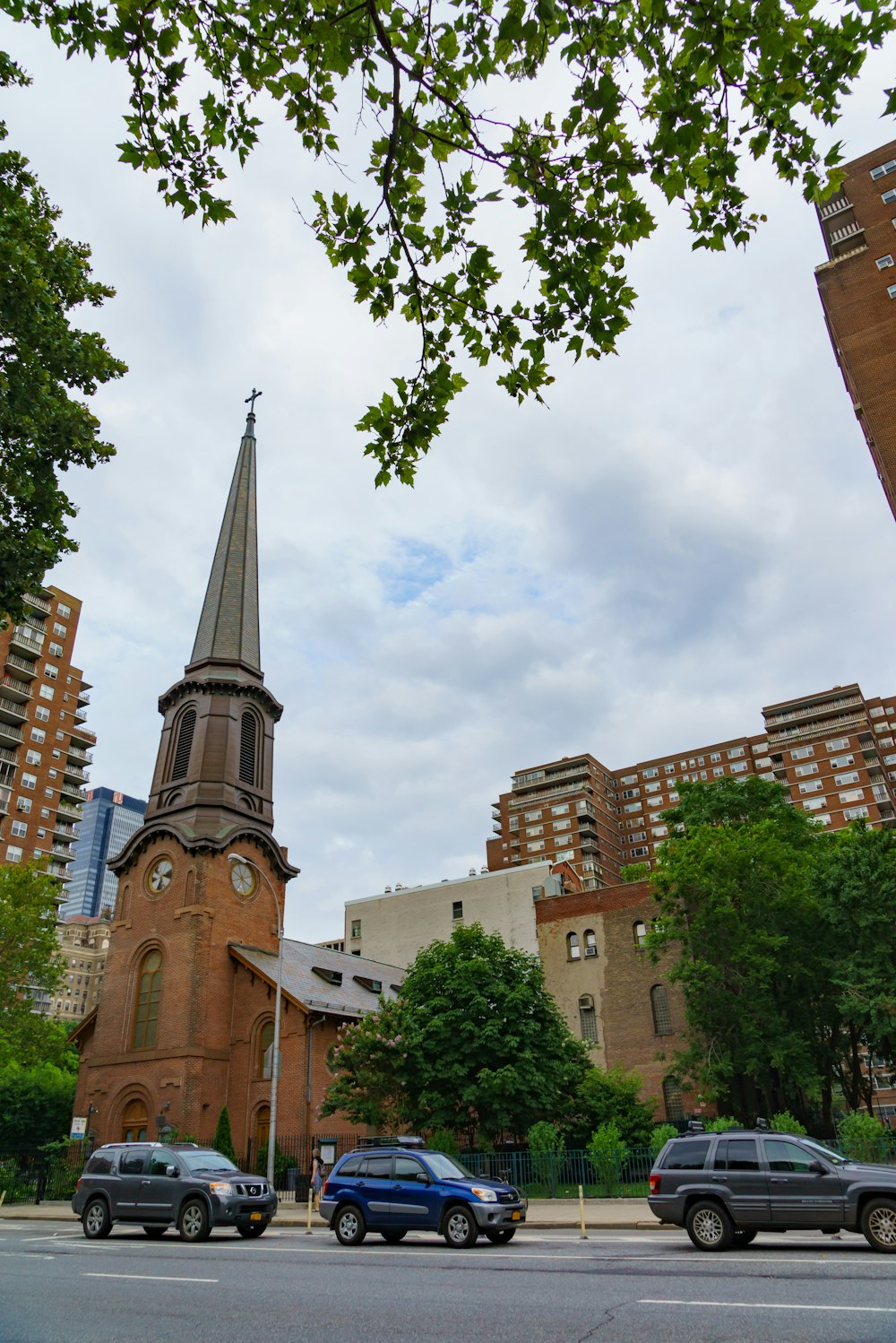 a group of cars parked in front of a church