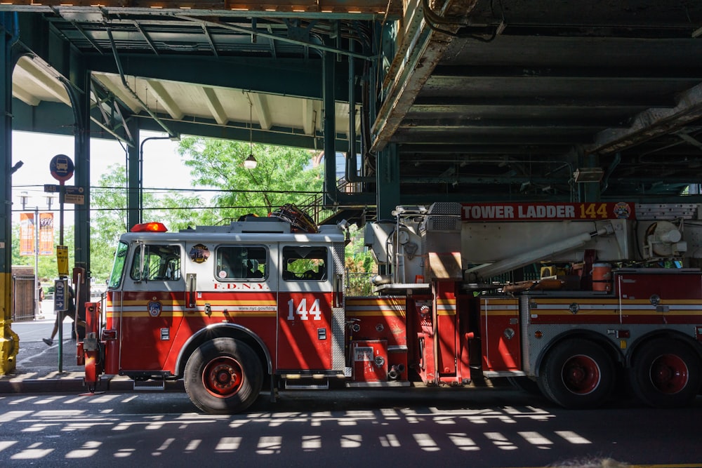 a fire truck parked under a bridge