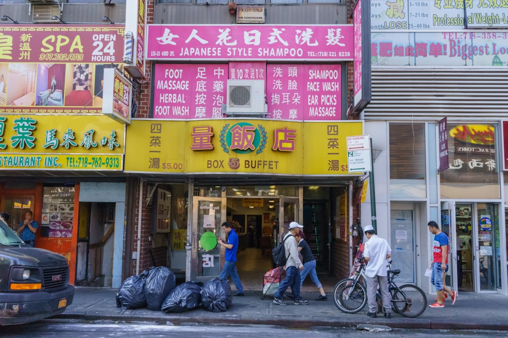 a group of people walking on the sidewalk