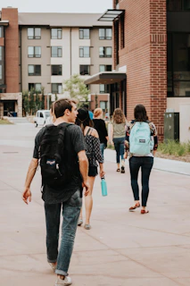 a group of people walking on a sidewalk
