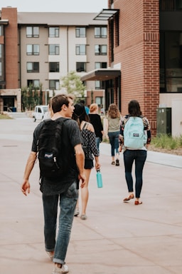 a group of people walking on a sidewalk