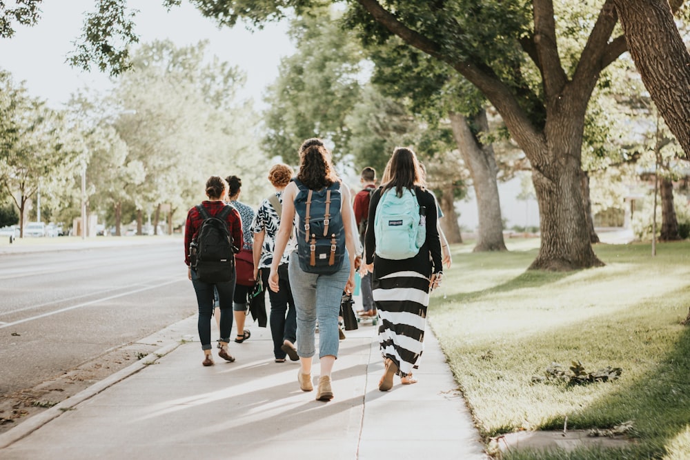 a group of people walking on a road