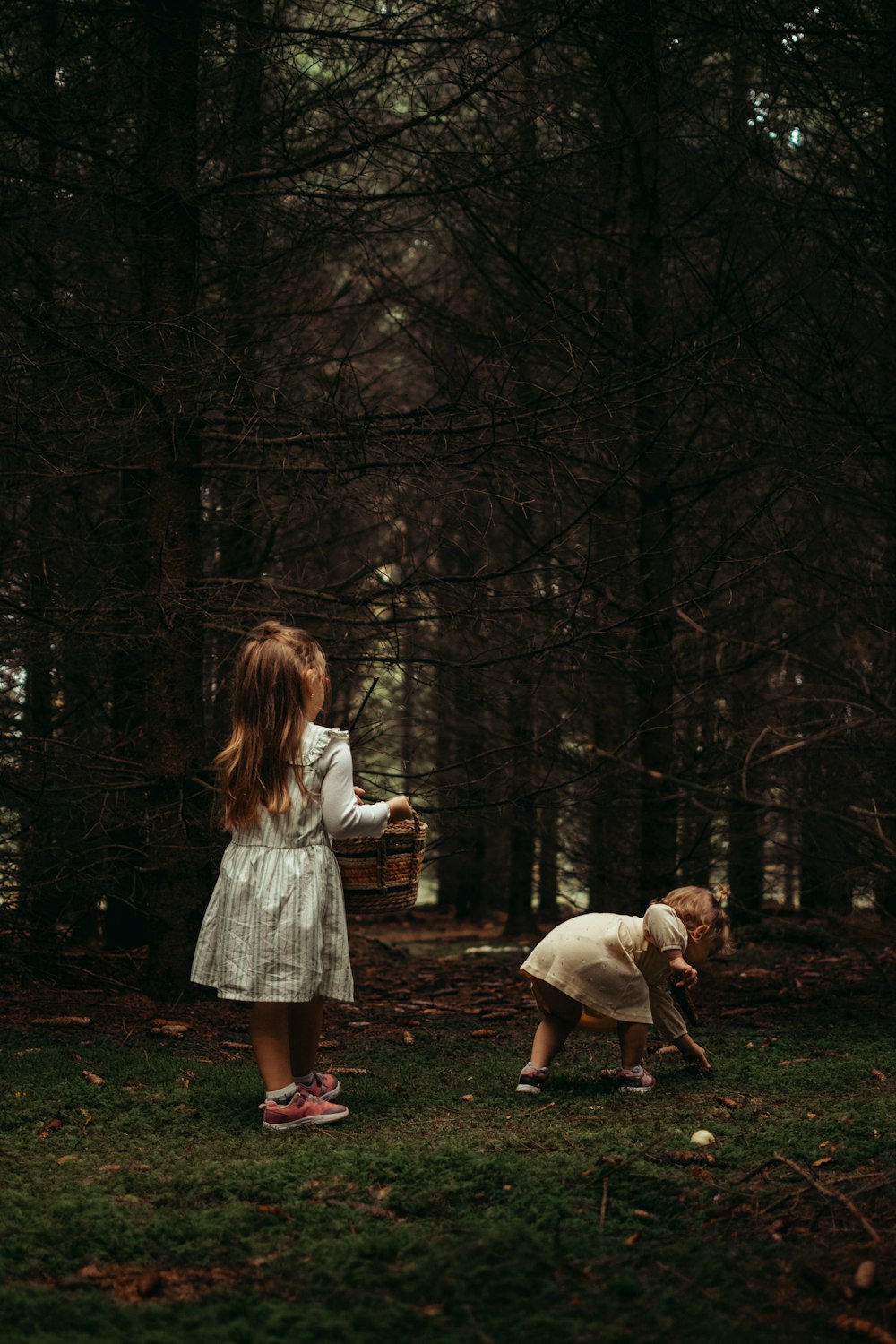 a person and a girl playing in the woods