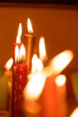 Brightly lit shot of a set of handmade candles with warm glow