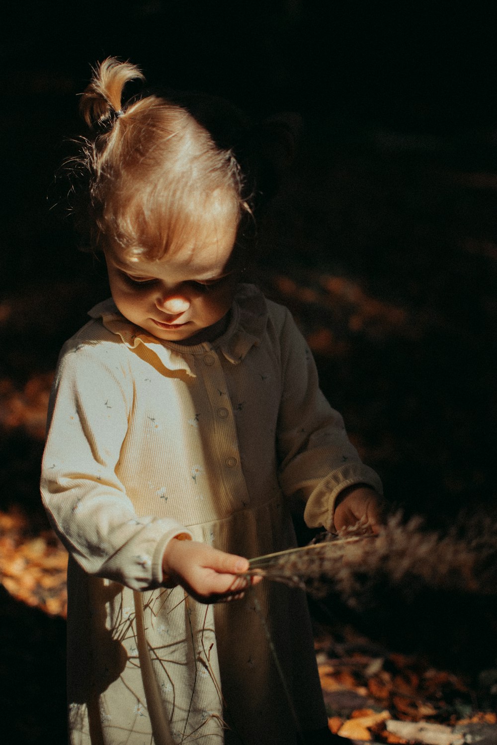 a little girl holding a stick