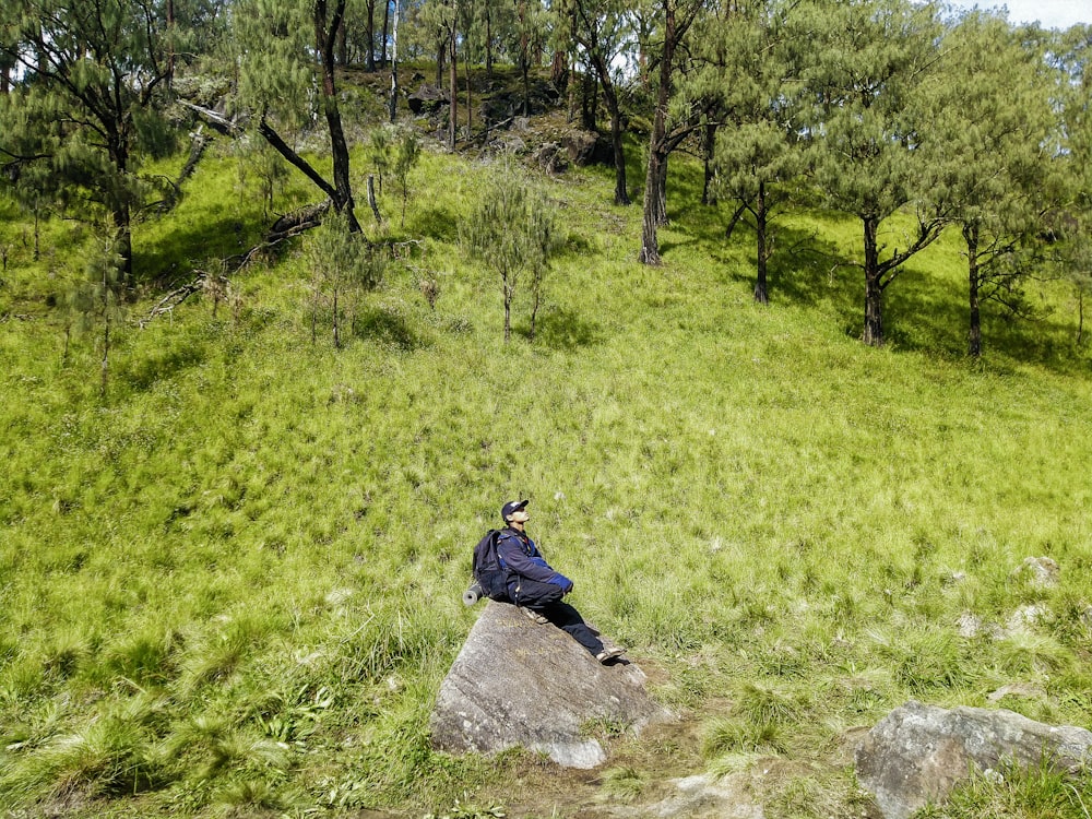 a person sitting on a rock