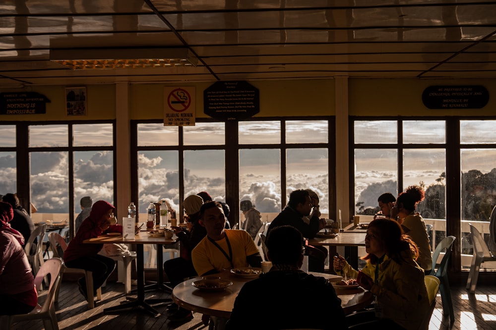 people sitting at tables in a restaurant