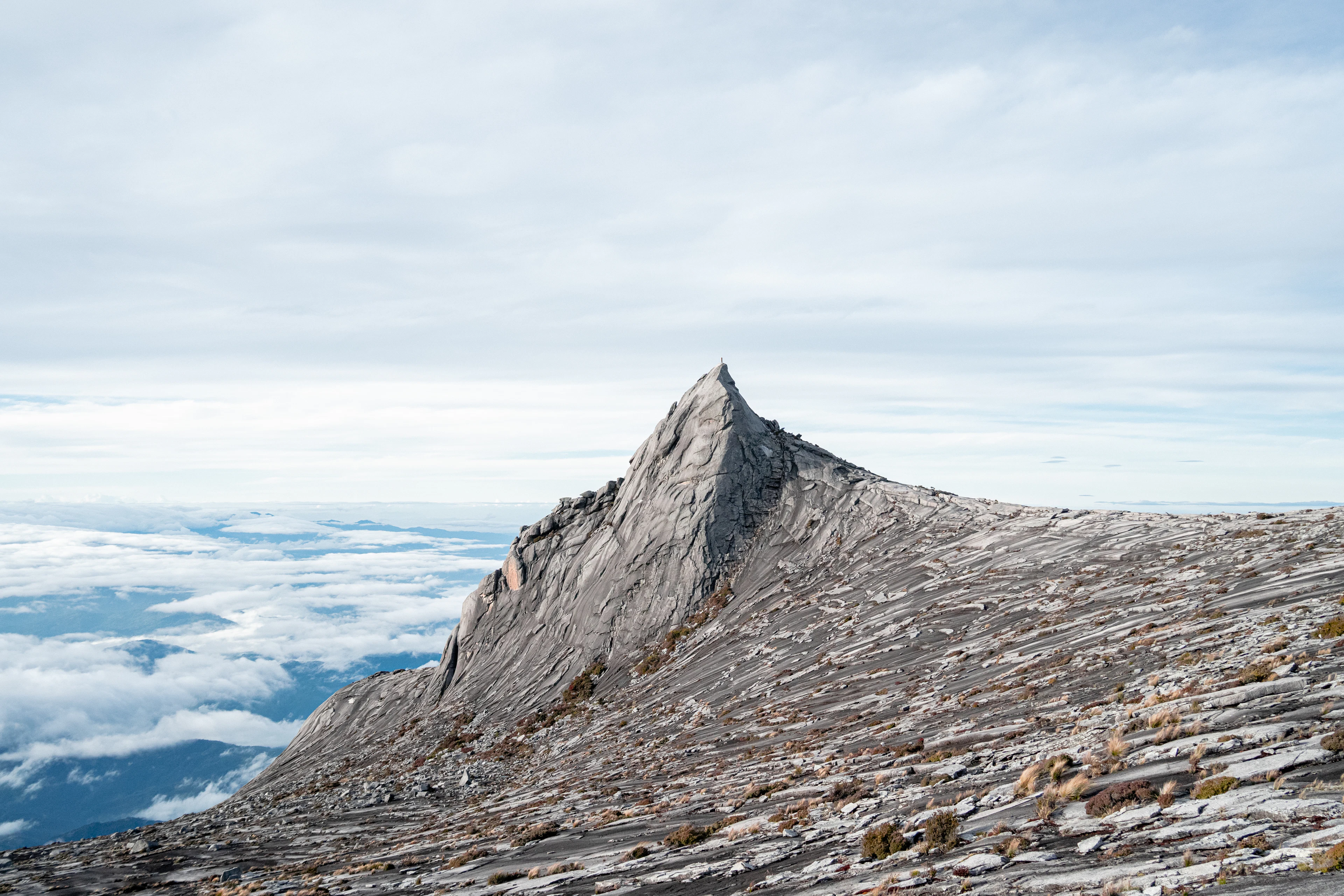 The granite summit of Mount Kinabalu above the clouds, Sabah, Malaysian Borneo