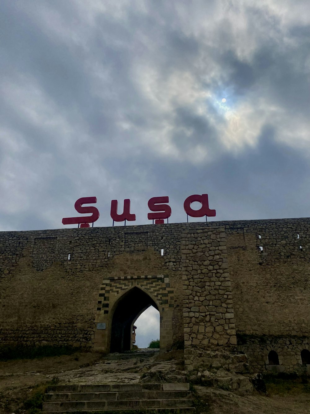 a stone building with a sign on it