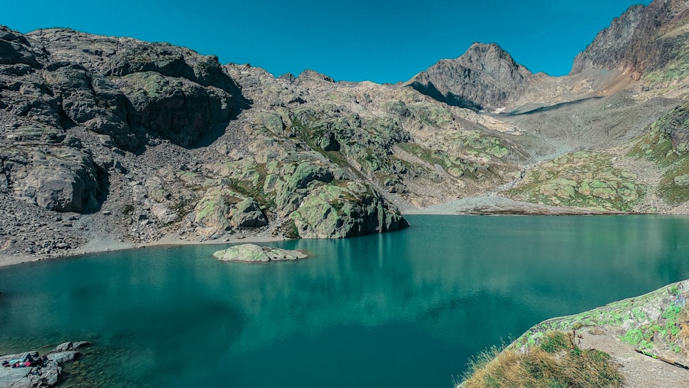 a body of water with mountains in the background