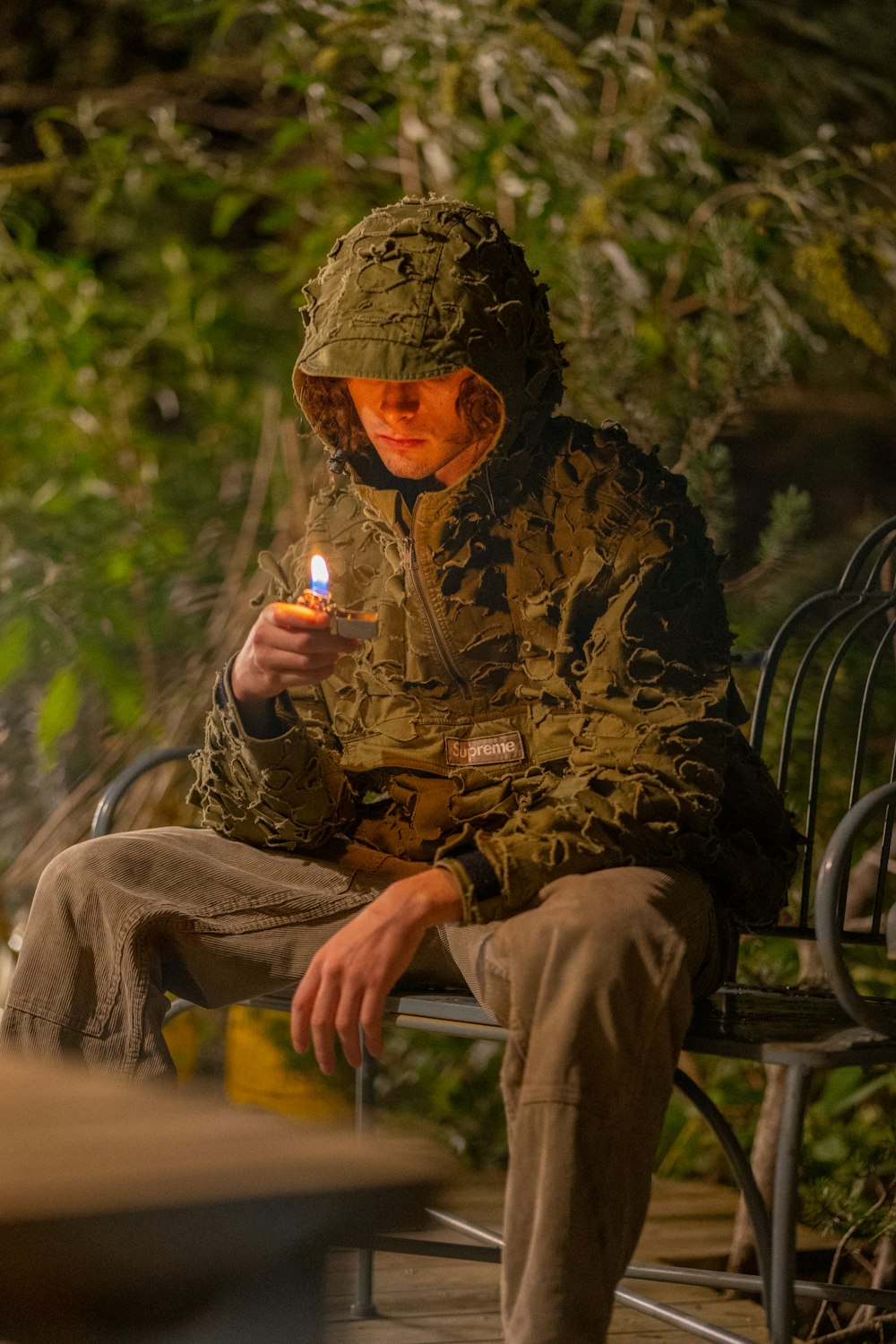 a man in military uniform sitting on a chair with a lit candle