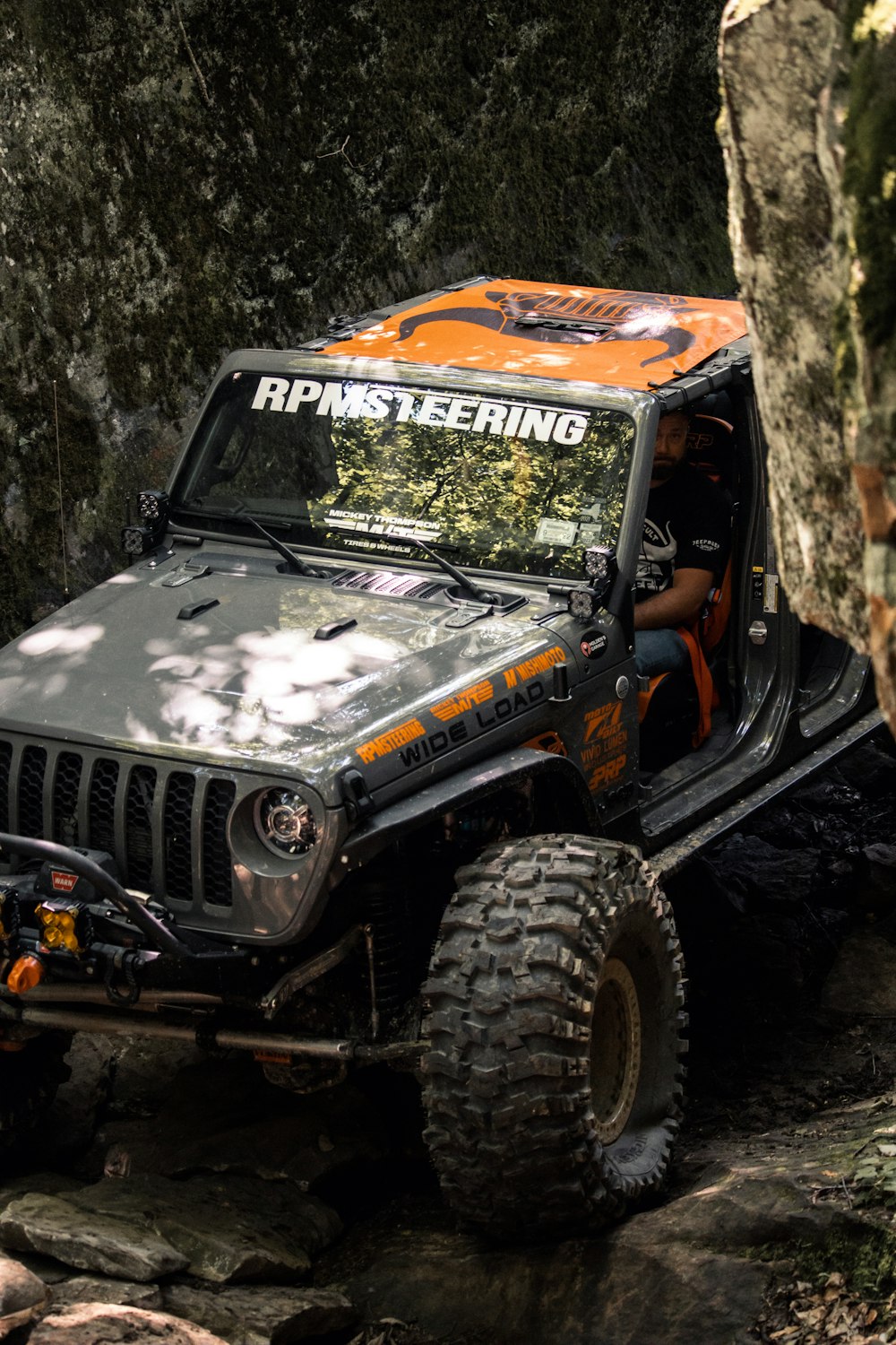 a black jeep with a person inside