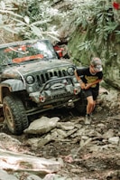 a man standing next to a jeep
