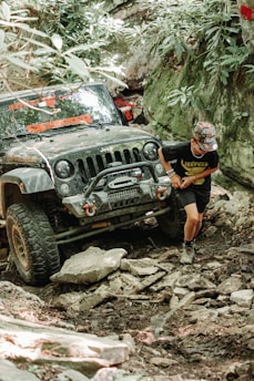 a man standing next to a jeep