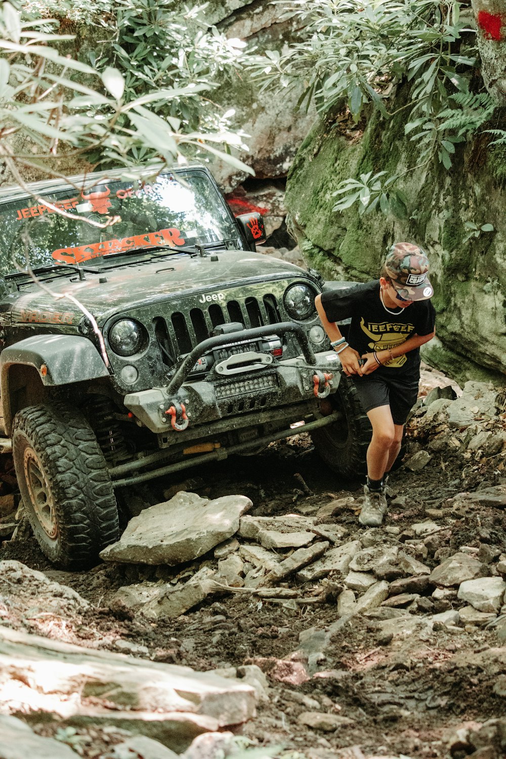 a man standing next to a jeep