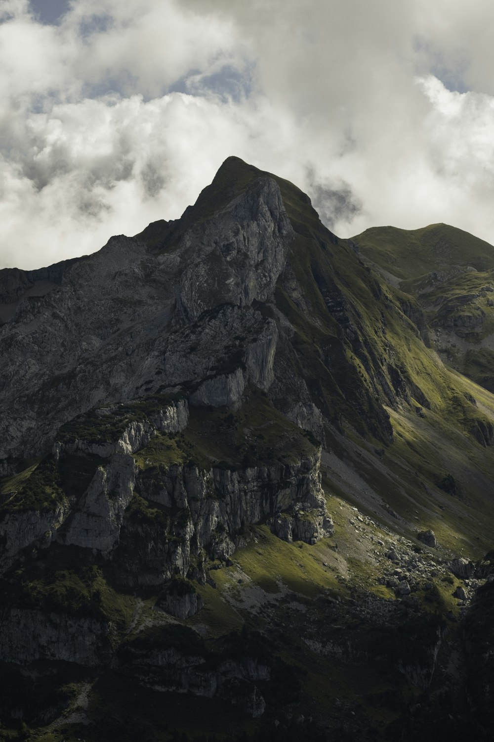 a rocky mountain with clouds