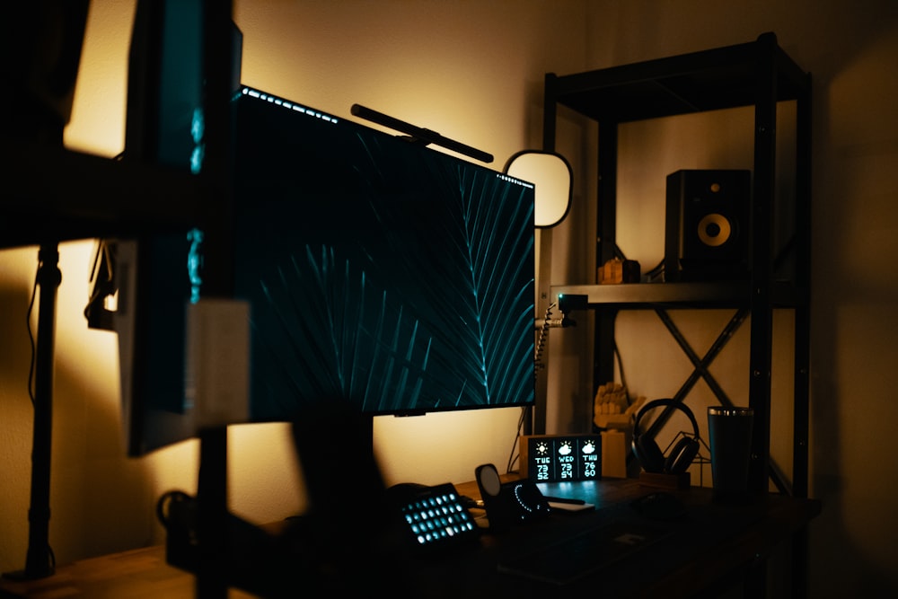 a desk with a computer and speakers