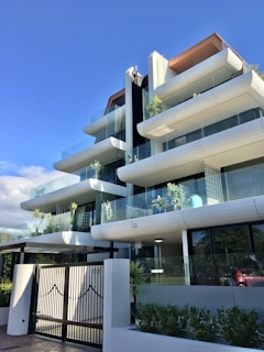 Photo of a well-maintained condominium entrance with clean landscaping and modern design.