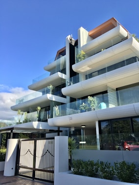Modern residential building with integrated smart home technology visible on balconies and entrances