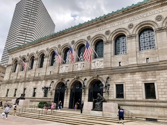 Historic public library or government building with American flags and classical architecture.