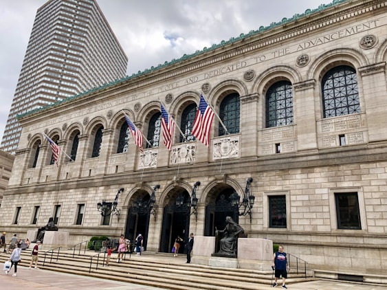 Historic public library or government building with American flags and classical architecture.