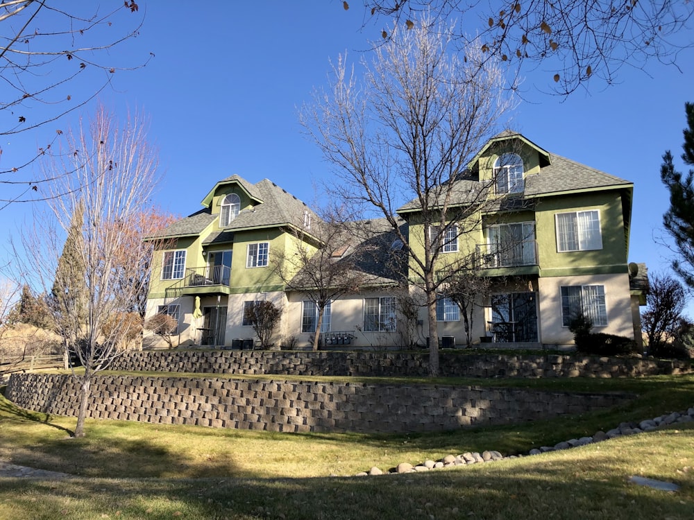 a large house with a stone wall