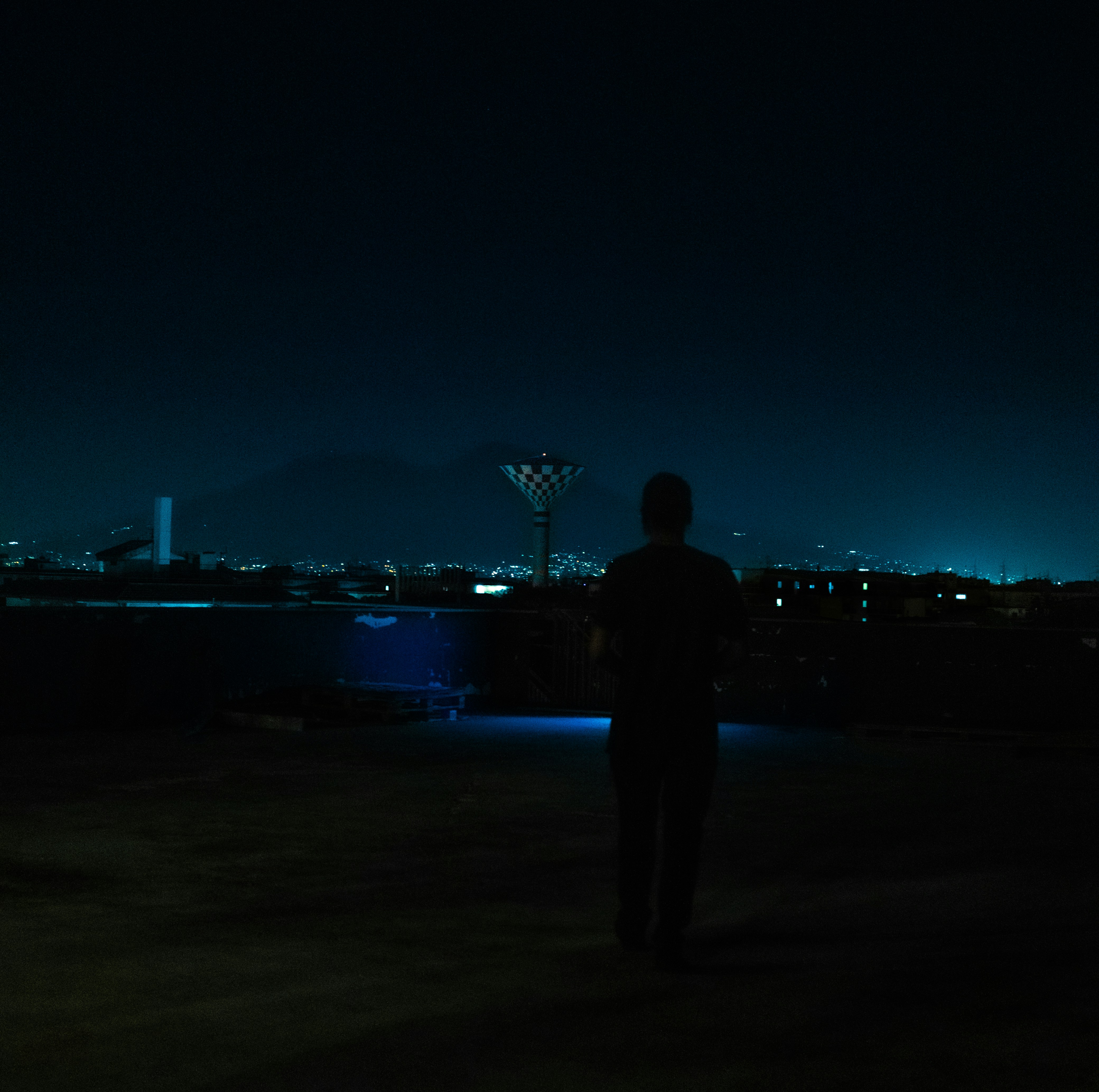 a man standing on a beach at night